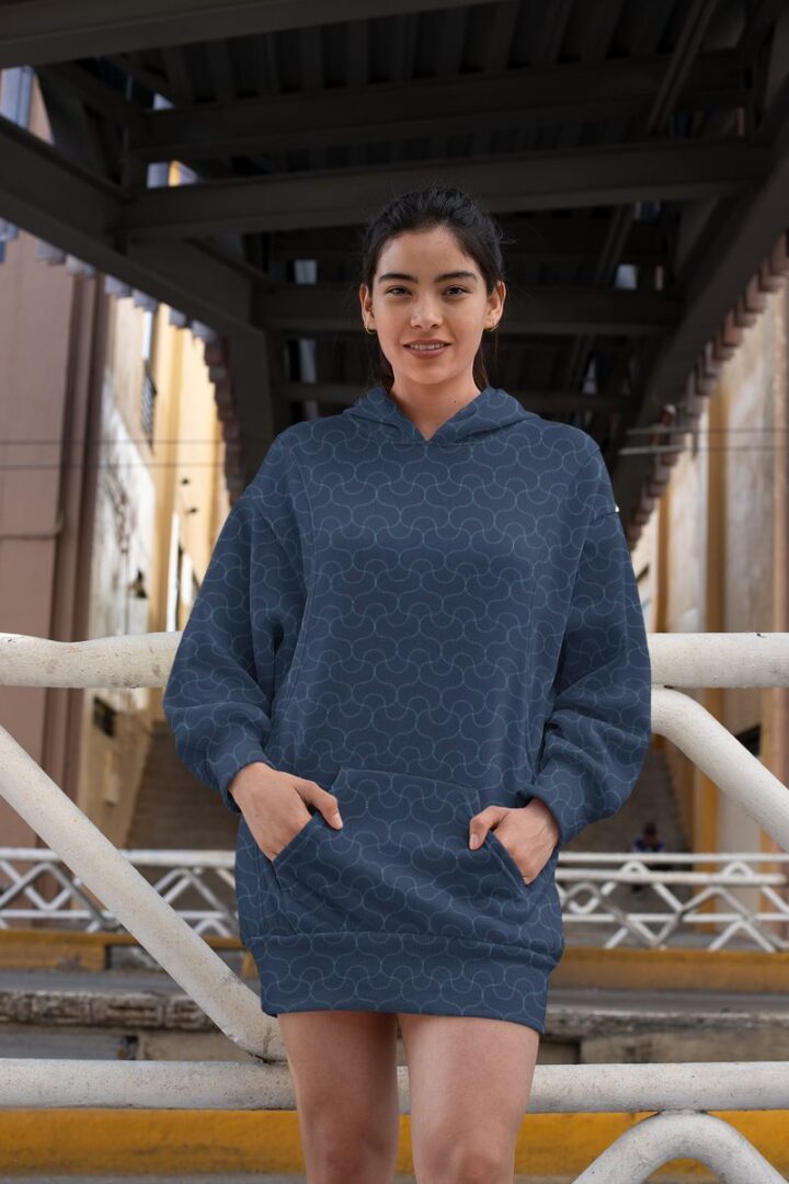 Woman wearing a navy all-over-print hoodie dress by Hoodie Lab