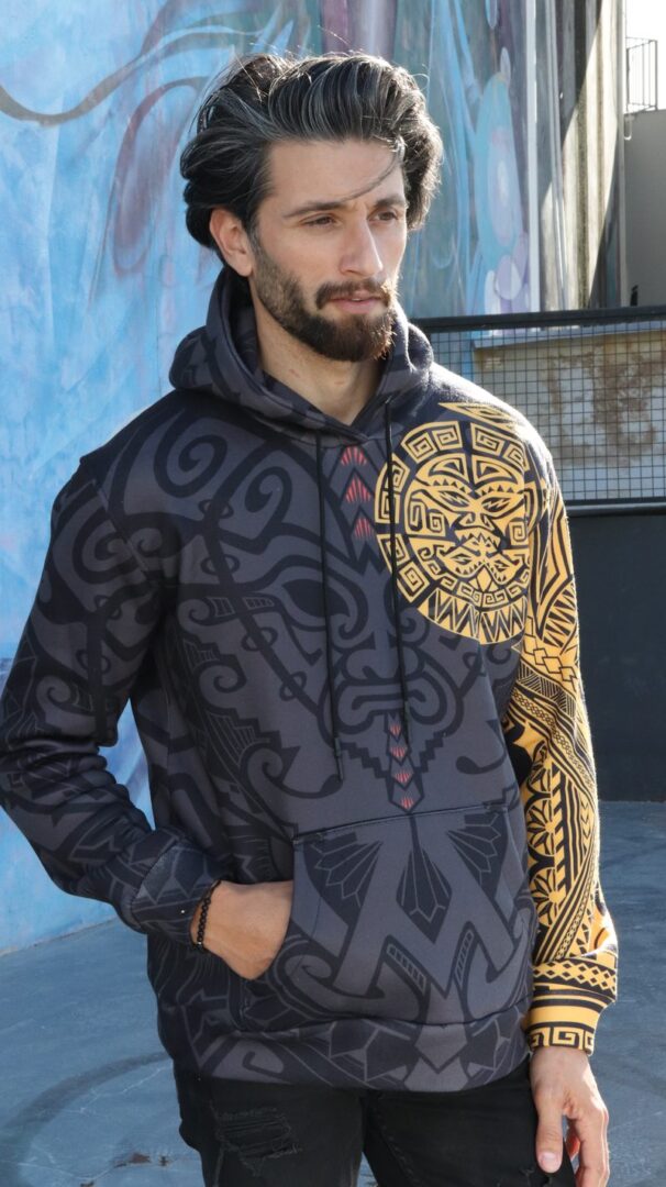 Man wearing an all-over-print hoodie by Hoodie Lab on a city street