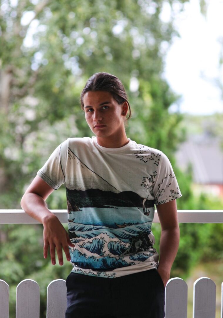 Young person wearing an all-over-print kids t-shirt by Hoodie Lab