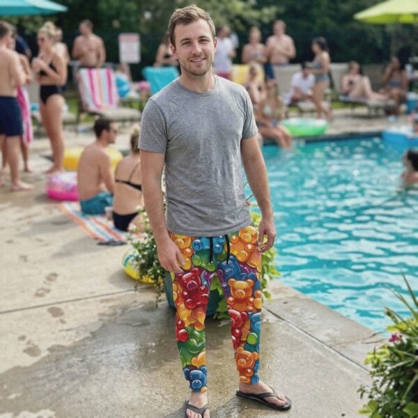 Man wearing Gummy Bear Chaos joggers at a pool party