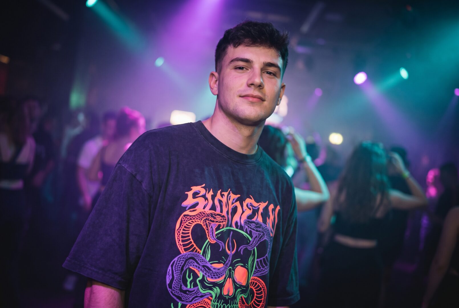 Man in a bold skull-print graphic t-shirt at a rave